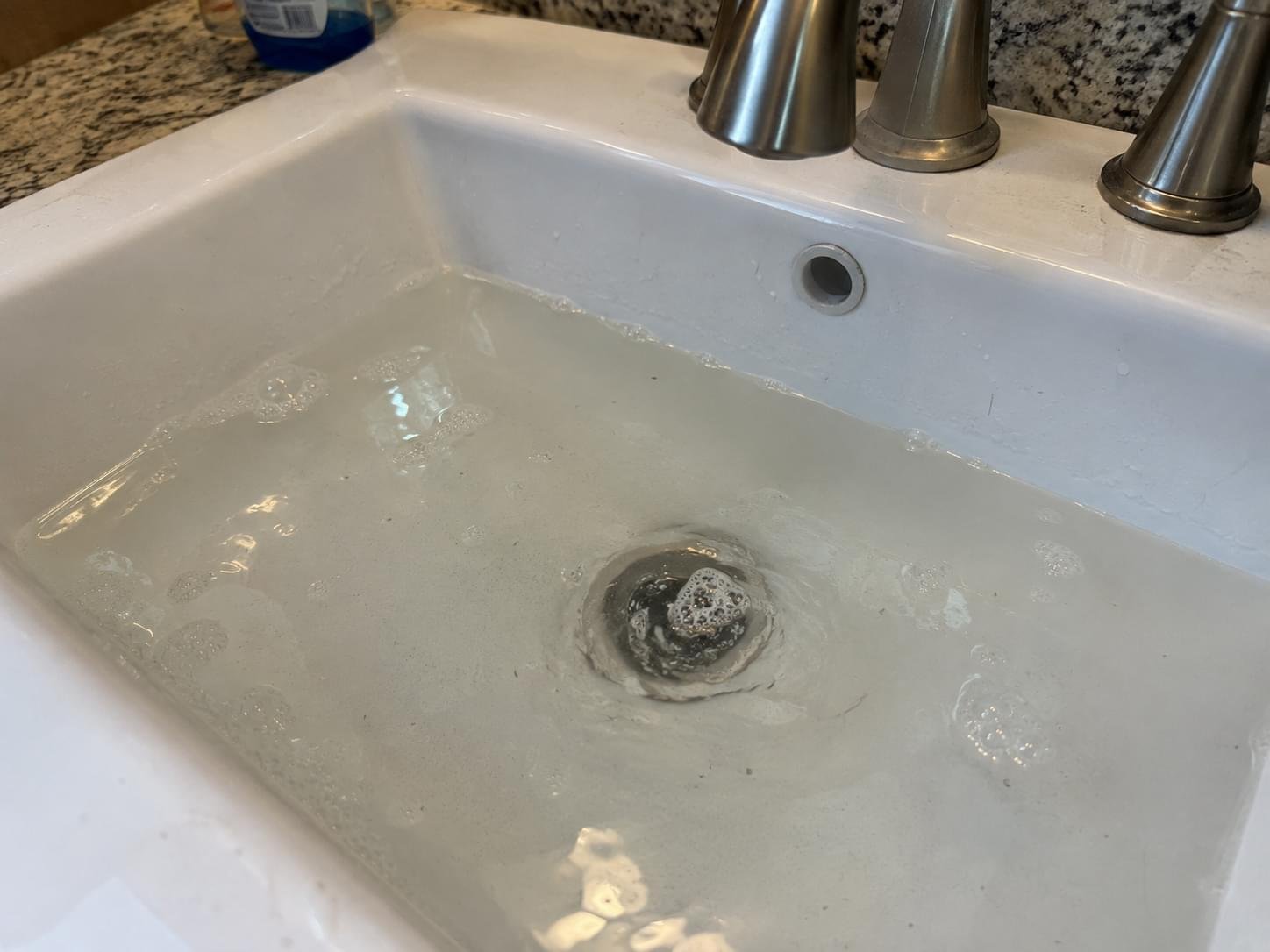 Slow clogged household drain with standing water in a Chandler Arizona home